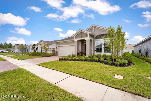 75013 Pondside Ln, Yulee, FL 32097 - view of front of home with board and batten siding, an attached garage, driveway, and a front yard