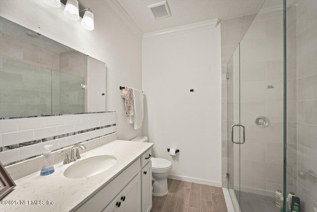75013 Pondside Ln, Yulee, FL 32097 - bathroom featuring crown molding, vanity, a shower stall, backsplash, and wood finished floors
