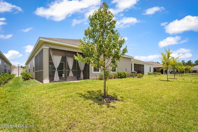 75013 Pondside Ln, Yulee, FL 32097 - back of property with a yard and a sunroom