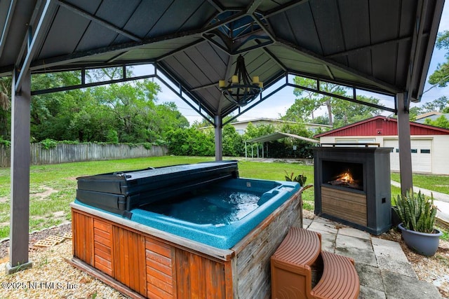 2510 Cesery Blvd, Jacksonville, FL 32211 - view of patio / terrace with a hot tub and a lit fireplace
