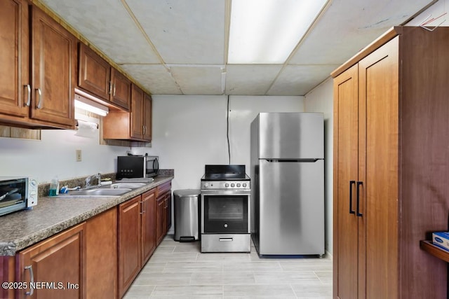 2510 Cesery Blvd, Jacksonville, FL 32211 - kitchen featuring stainless steel appliances and brown cabinetry