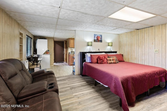 2510 Cesery Blvd, Jacksonville, FL 32211 - bedroom with wooden walls, light wood-style flooring, and a paneled ceiling