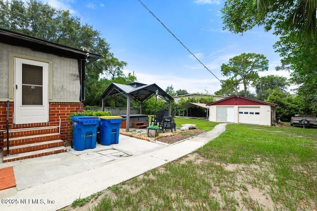 2510 Cesery Blvd, Jacksonville, FL 32211 - view of grassy yard featuring a gazebo, entry steps, a detached garage, and an outdoor structure