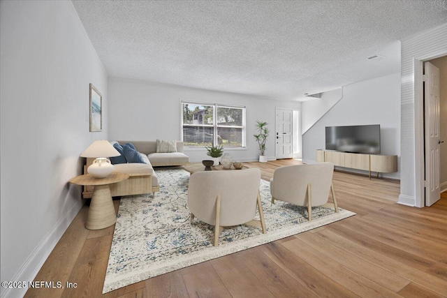 695 A1A Unit 146, Ponte Vedra Beach, FL 32082 - living room featuring a textured ceiling and wood finished floors