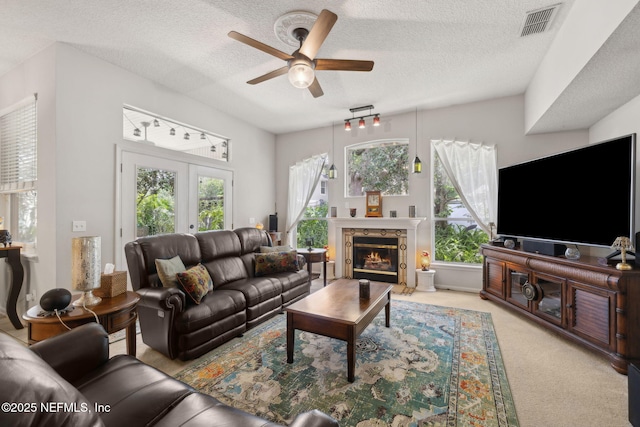 1208 Kyle Way S, Saint Johns, FL 32259 - living area featuring a ceiling fan, a textured ceiling, plenty of natural light, light carpet, and a fireplace