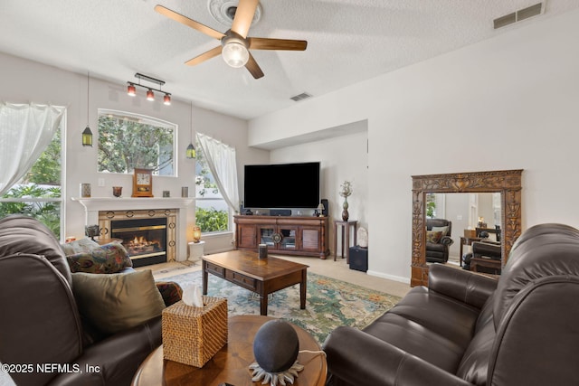 1208 Kyle Way S, Saint Johns, FL 32259 - living room with a textured ceiling, a ceiling fan, a glass covered fireplace, and carpet floors