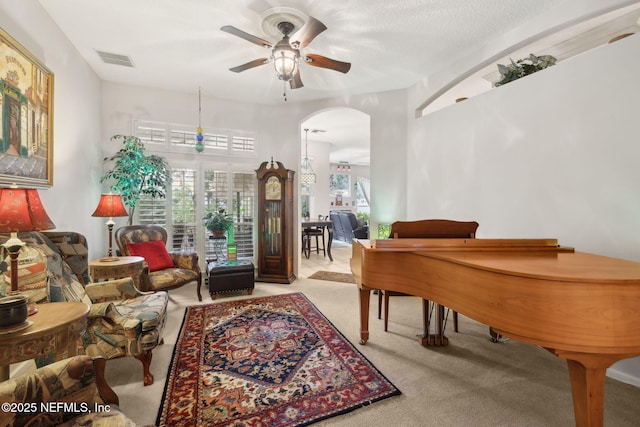 1208 Kyle Way S, Saint Johns, FL 32259 - living area featuring arched walkways, a ceiling fan, and carpet flooring
