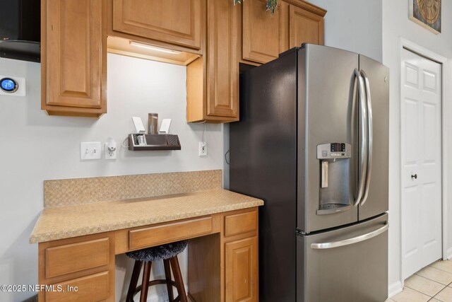 1208 Kyle Way S, Saint Johns, FL 32259 - kitchen featuring stainless steel refrigerator with ice dispenser, built in desk, light countertops, and light tile patterned floors