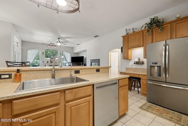 1208 Kyle Way S, Saint Johns, FL 32259 - kitchen featuring appliances with stainless steel finishes, ceiling fan, light countertops, light tile patterned floors, and arched walkways