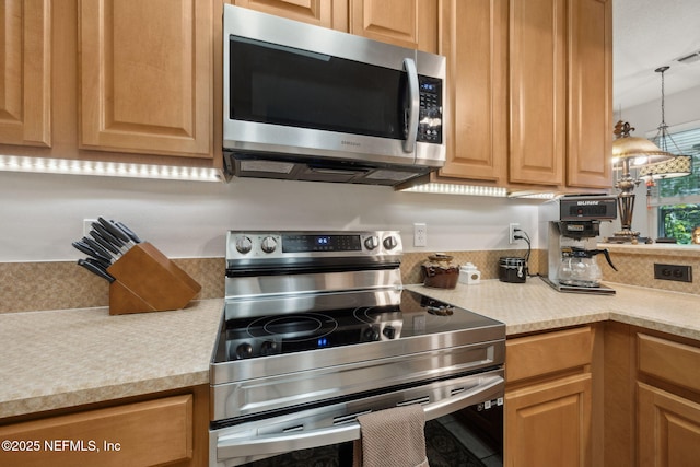 1208 Kyle Way S, Saint Johns, FL 32259 - kitchen with appliances with stainless steel finishes, light countertops, and hanging light fixtures