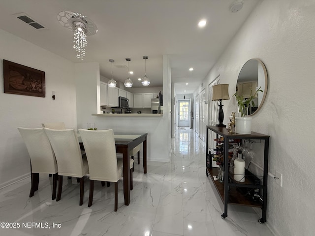 106 Sunrise Ct, Atlantic Beach, FL 32233 - dining room with a textured wall, light marble finish flooring, and recessed lighting