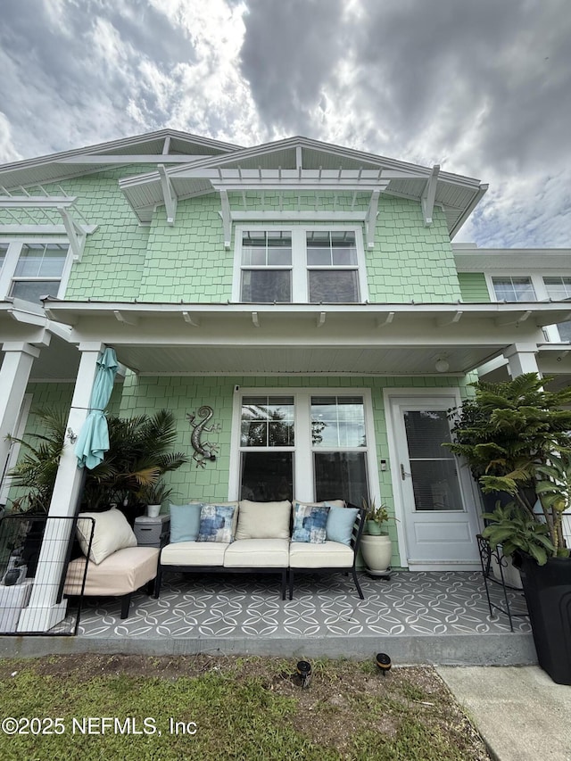 106 Sunrise Ct, Atlantic Beach, FL 32233 - back of house featuring an outdoor living space