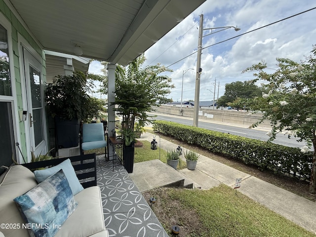 106 Sunrise Ct, Atlantic Beach, FL 32233 - covered porch with outdoor lounge area
