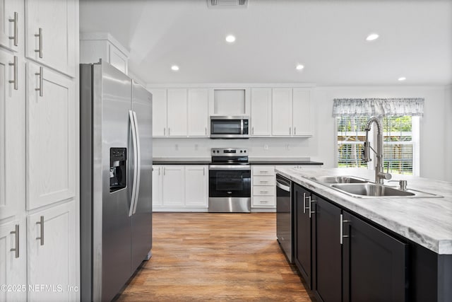 2254 Stauffer Rd, Green Cove Springs, FL 32043 - kitchen featuring stainless steel appliances, white cabinetry, light wood finished floors, recessed lighting, and light countertops