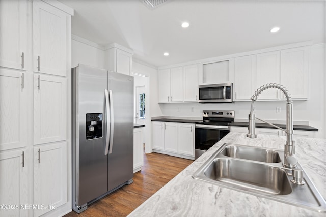 2254 Stauffer Rd, Green Cove Springs, FL 32043 - kitchen featuring appliances with stainless steel finishes, white cabinetry, wood finished floors, recessed lighting, and light stone counters