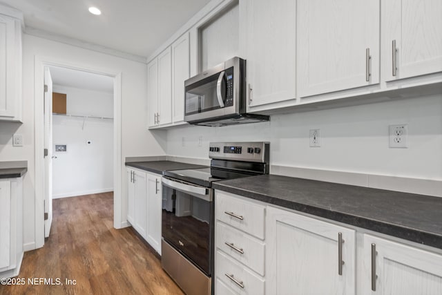 2254 Stauffer Rd, Green Cove Springs, FL 32043 - kitchen with appliances with stainless steel finishes, dark countertops, dark wood-type flooring, white cabinets, and recessed lighting