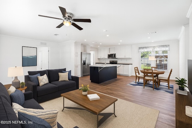 2254 Stauffer Rd, Green Cove Springs, FL 32043 - living room with light wood-style floors, recessed lighting, a ceiling fan, and crown molding