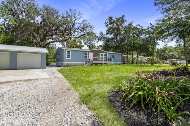 2254 Stauffer Rd, Green Cove Springs, FL 32043 - manufactured / mobile home with an outbuilding, a garage, and concrete driveway