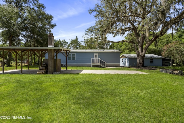 2254 Stauffer Rd, Green Cove Springs, FL 32043 - back of house featuring a chimney, a yard, and a patio