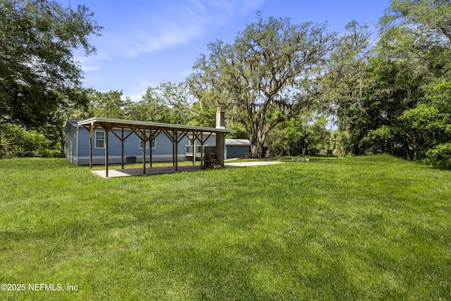 2254 Stauffer Rd, Green Cove Springs, FL 32043 - view of grassy yard featuring a patio and view of scattered trees