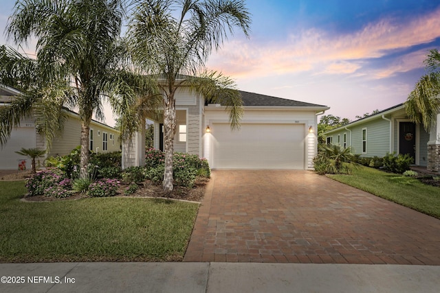 985 Rustic Mill Dr, Saint Augustine, FL 32092 - view of front of house featuring decorative driveway, an attached garage, and a front lawn