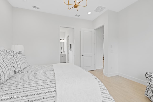 985 Rustic Mill Dr, Saint Augustine, FL 32092 - bedroom with light wood finished floors, a chandelier, recessed lighting, and ensuite bath