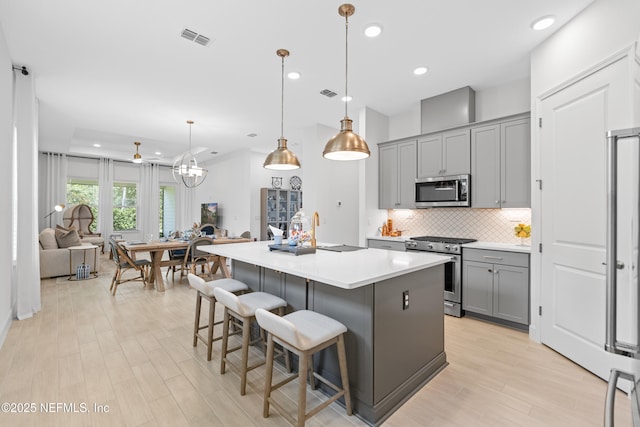 985 Rustic Mill Dr, Saint Augustine, FL 32092 - kitchen featuring appliances with stainless steel finishes, gray cabinets, backsplash, a kitchen island, and recessed lighting