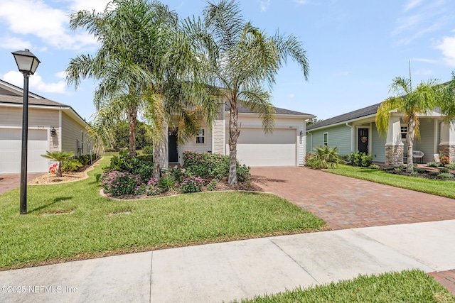985 Rustic Mill Dr, Saint Augustine, FL 32092 - view of front facade with decorative driveway, a front lawn, and a garage