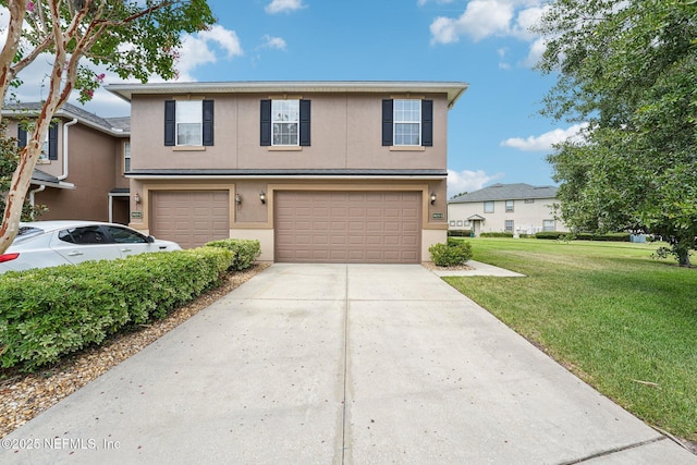 3905 Buckthorne Dr Unit D, Orange Park, FL 32065 - view of front facade with an attached garage, stucco siding, a front yard, and concrete driveway