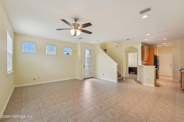 3905 Buckthorne Dr Unit D, Orange Park, FL 32065 - unfurnished living room featuring light tile patterned floors, ceiling fan, arched walkways, stairway, and recessed lighting
