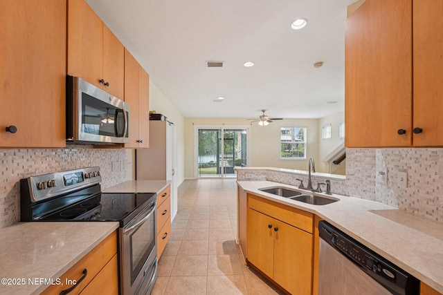 3905 Buckthorne Dr Unit D, Orange Park, FL 32065 - kitchen featuring stainless steel appliances, light countertops, tasteful backsplash, light tile patterned floors, and a ceiling fan