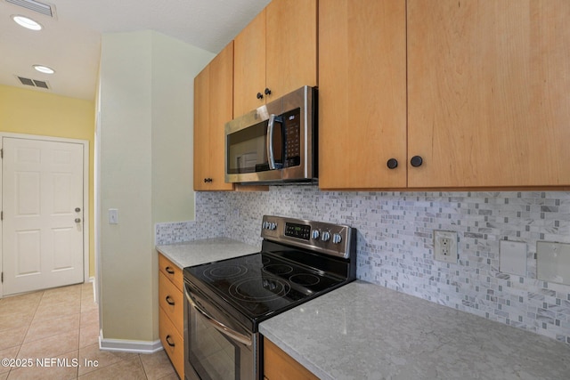 3905 Buckthorne Dr Unit D, Orange Park, FL 32065 - kitchen with stainless steel appliances, light tile patterned floors, and tasteful backsplash