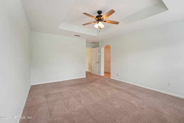 3905 Buckthorne Dr Unit D, Orange Park, FL 32065 - unfurnished room with a tray ceiling, arched walkways, ceiling fan, and carpet