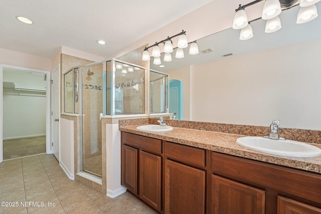 3905 Buckthorne Dr Unit D, Orange Park, FL 32065 - full bath with a shower stall, a spacious closet, tile patterned flooring, double vanity, and recessed lighting