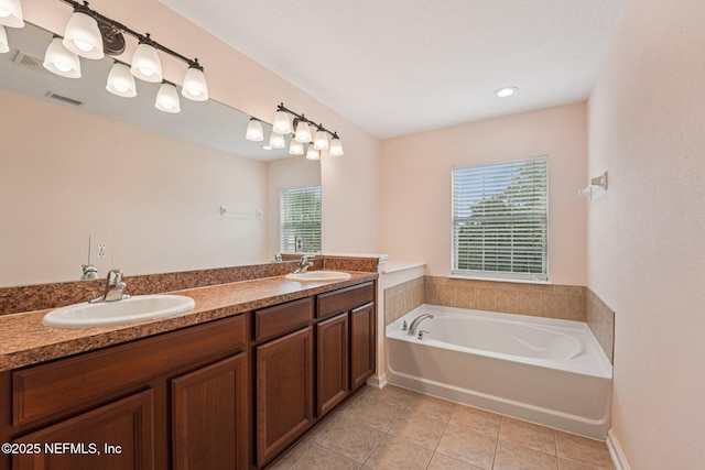 3905 Buckthorne Dr Unit D, Orange Park, FL 32065 - bathroom with tile patterned flooring, healthy amount of natural light, a garden tub, and double vanity