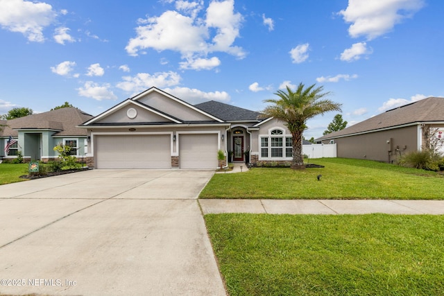 95212 Tanglewood Dr, Fernandina Beach, FL 32034 - single story home featuring an attached garage, driveway, stone siding, and stucco siding