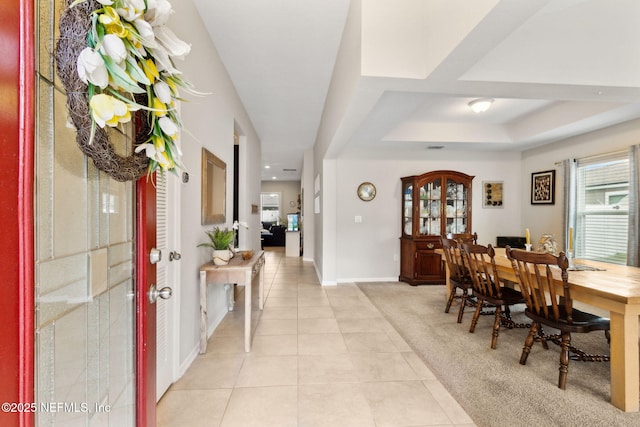 95212 Tanglewood Dr, Fernandina Beach, FL 32034 - foyer entrance featuring light tile patterned flooring, a tray ceiling, french doors, and light carpet