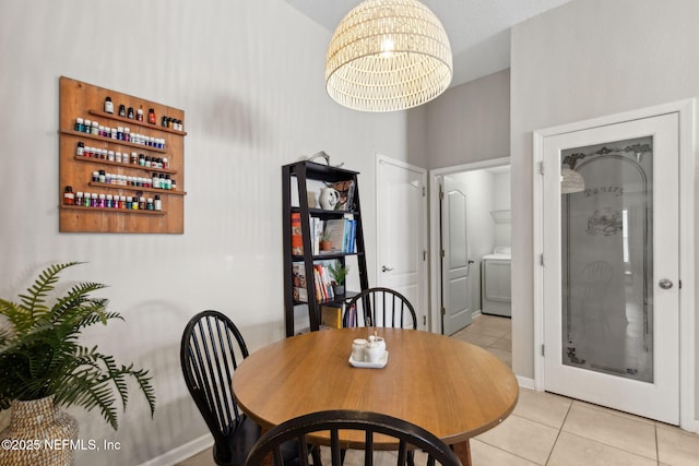 95212 Tanglewood Dr, Fernandina Beach, FL 32034 - dining room featuring light tile patterned floors, a chandelier, and washer / dryer