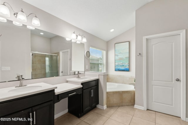 95212 Tanglewood Dr, Fernandina Beach, FL 32034 - full bathroom with a stall shower, double vanity, tile patterned floors, vaulted ceiling, and a garden tub