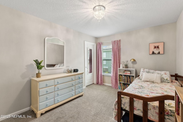 95212 Tanglewood Dr, Fernandina Beach, FL 32034 - carpeted bedroom featuring a chandelier and a textured ceiling