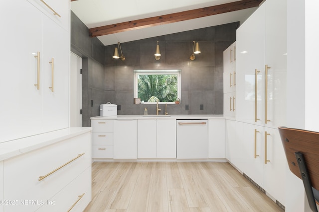 411 S St, Neptune Beach, FL 32266 - kitchen with white dishwasher, light countertops, light wood-type flooring, and white cabinets