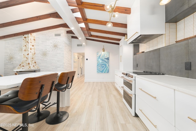 411 S St, Neptune Beach, FL 32266 - kitchen featuring white electric range oven, beam ceiling, white cabinets, light countertops, and light wood-style flooring