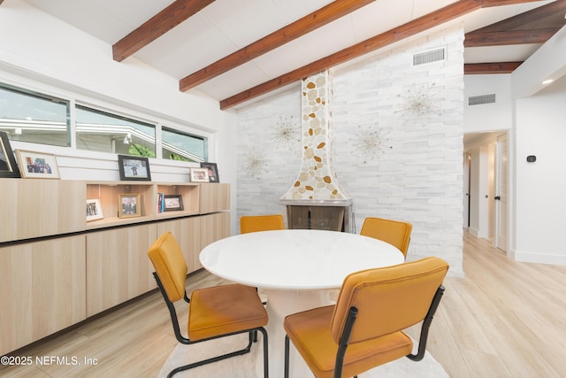 411 S St, Neptune Beach, FL 32266 - dining area with light wood finished floors, beam ceiling, and high vaulted ceiling