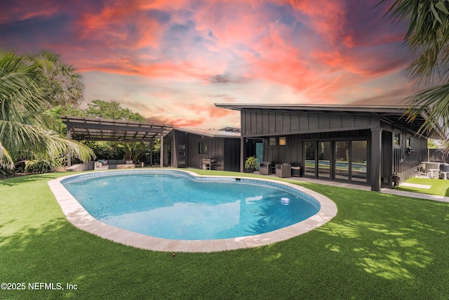 411 S St, Neptune Beach, FL 32266 - pool at dusk with an outdoor pool, a yard, an outdoor hangout area, and a pergola