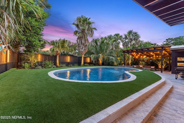 411 S St, Neptune Beach, FL 32266 - pool at dusk featuring a pergola, a fenced backyard, and an outdoor hangout area