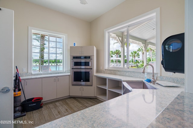 71 Ash Breeze Cv, Saint Augustine, FL 32095 - kitchen with double oven, healthy amount of natural light, and wood finished floors