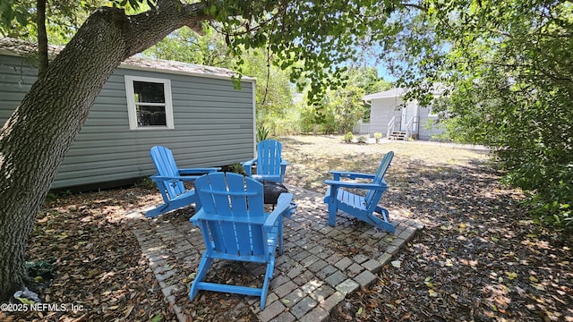 1319 Hickory St, Fernandina Beach, FL 32034 - view of yard with an outdoor fire pit, a patio area, and an outdoor structure