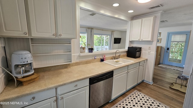1319 Hickory St, Fernandina Beach, FL 32034 - kitchen featuring dishwasher, white cabinets, light countertops, dark wood-style floors, and a textured ceiling