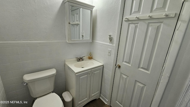 1319 Hickory St, Fernandina Beach, FL 32034 - half bath with vanity, wainscoting, tile walls, and a textured wall