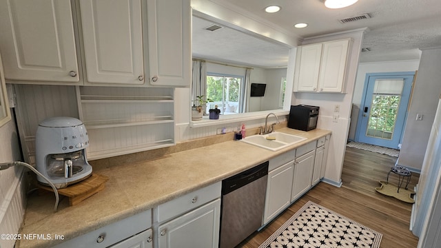 1319 Hickory St, Fernandina Beach, FL 32034 - kitchen with dishwasher, white cabinetry, dark wood-type flooring, light countertops, and a textured ceiling